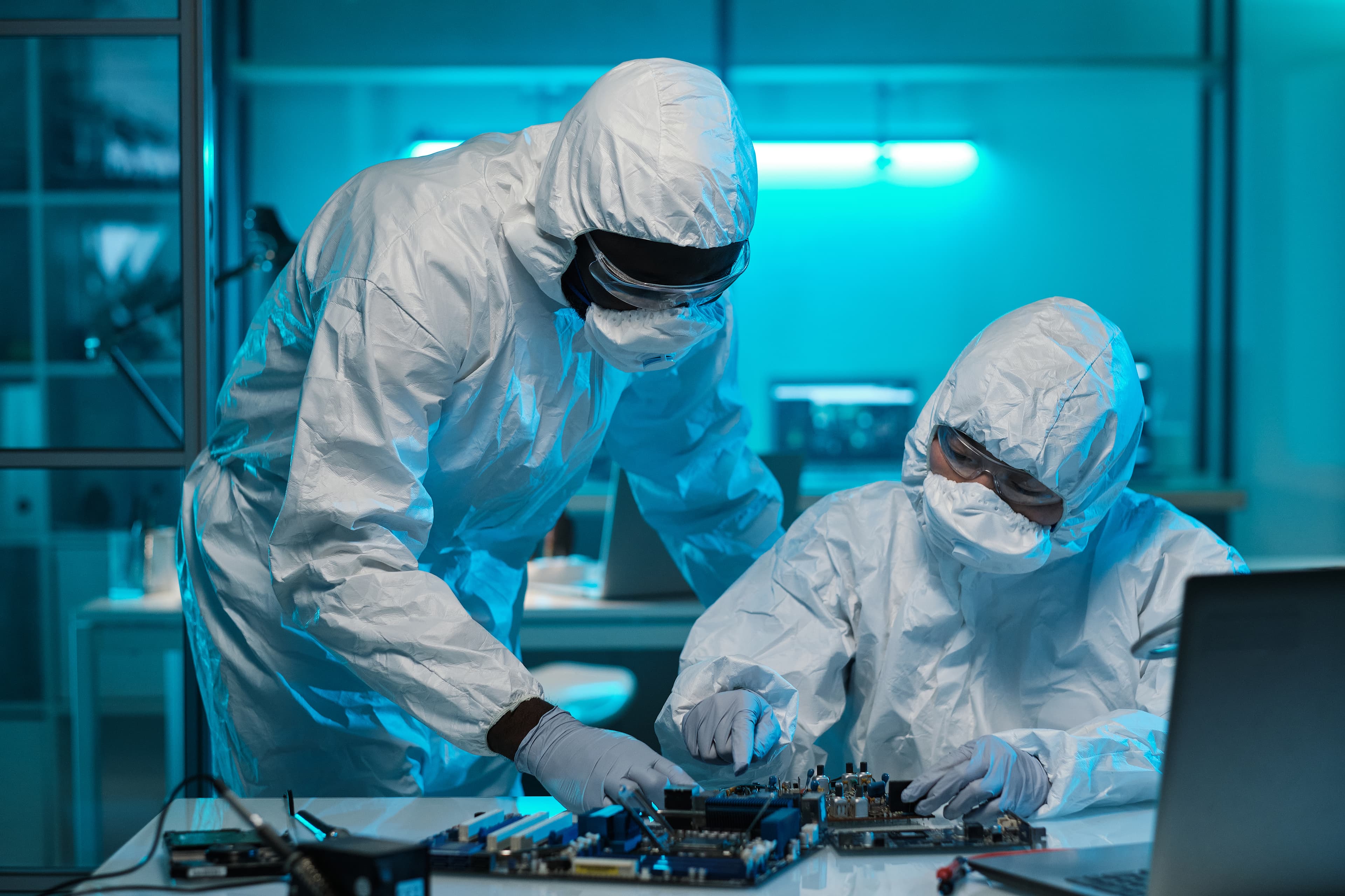 Engineers and technicians collaborating on cleanroom medical device assembly